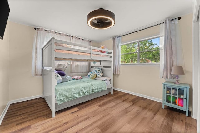 1215 Bois Darc St, Lockhart, TX 78644 - bedroom with baseboards and wood finished floors