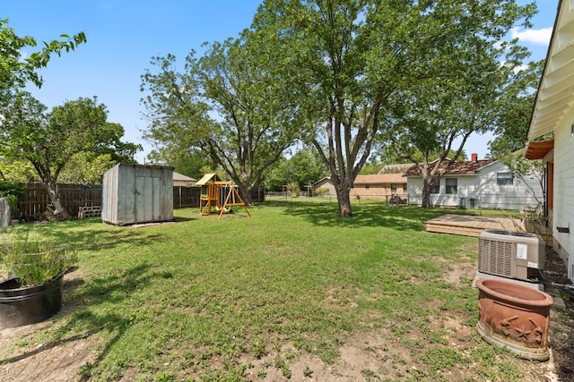 1215 Bois Darc St, Lockhart, TX 78644 - fenced backyard featuring a playground and a storage unit