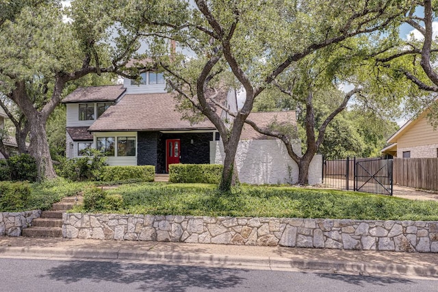 6904 Rusty Fig Dr, Austin, TX 78750 - view of front of property with a gate, roof with shingles, and stone siding