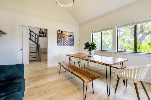 6904 Rusty Fig Dr, Austin, TX 78750 - dining room featuring plenty of natural light, stairway, light wood-type flooring, and high vaulted ceiling