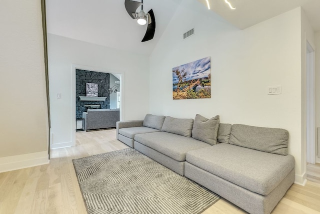 6904 Rusty Fig Dr, Austin, TX 78750 - living area with a ceiling fan, light wood-type flooring, a fireplace, and high vaulted ceiling