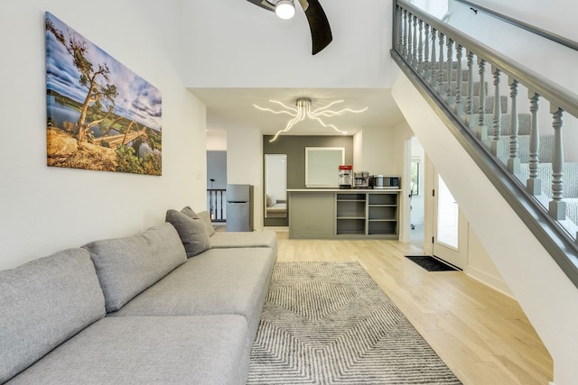 6904 Rusty Fig Dr, Austin, TX 78750 - living room with light wood-style floors, a chandelier, stairs, and a towering ceiling