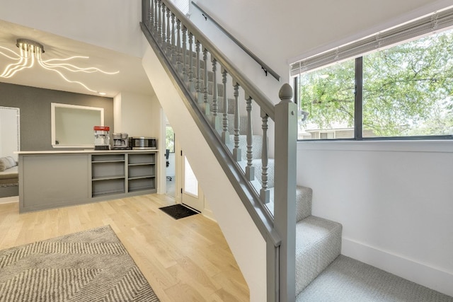 6904 Rusty Fig Dr, Austin, TX 78750 - staircase featuring wood finished floors and a chandelier