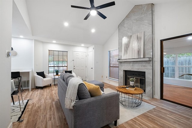 12307 Marogot Run, Austin, TX 78758 - living room with a fireplace, plenty of natural light, wood finished floors, high vaulted ceiling, and ceiling fan