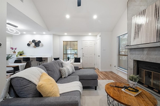 12307 Marogot Run, Austin, TX 78758 - living area featuring lofted ceiling, light wood-type flooring, recessed lighting, and a tile fireplace