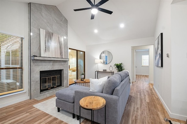 12307 Marogot Run, Austin, TX 78758 - living area featuring high vaulted ceiling, a ceiling fan, light wood-type flooring, and a tile fireplace