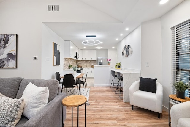 12307 Marogot Run, Austin, TX 78758 - living room with light wood-style flooring, recessed lighting, and lofted ceiling
