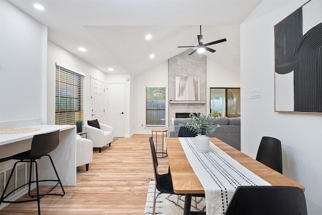 12307 Marogot Run, Austin, TX 78758 - dining space with vaulted ceiling, light wood-type flooring, recessed lighting, a ceiling fan, and a tiled fireplace