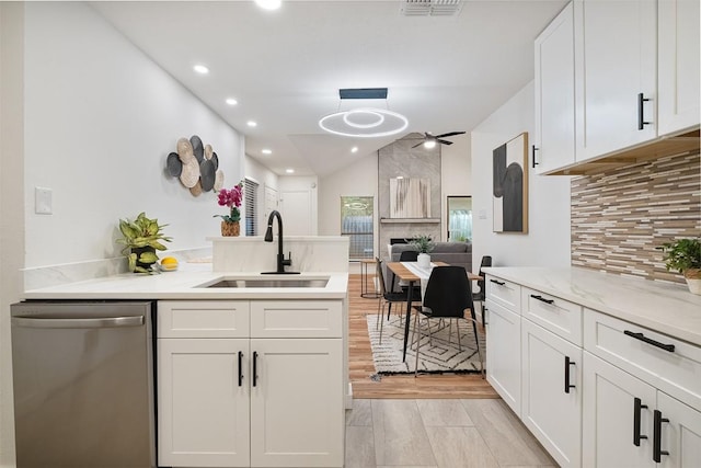 12307 Marogot Run, Austin, TX 78758 - kitchen featuring stainless steel dishwasher, ceiling fan, decorative backsplash, a peninsula, and recessed lighting