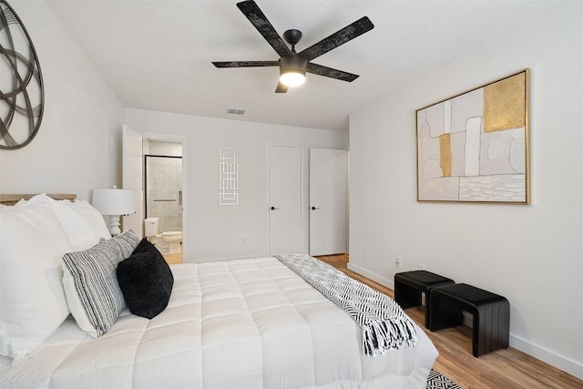 12307 Marogot Run, Austin, TX 78758 - bedroom with wood finished floors, ensuite bathroom, and a ceiling fan