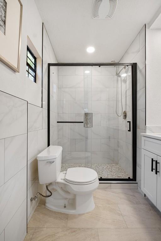 12307 Marogot Run, Austin, TX 78758 - bathroom with a stall shower, vanity, and recessed lighting