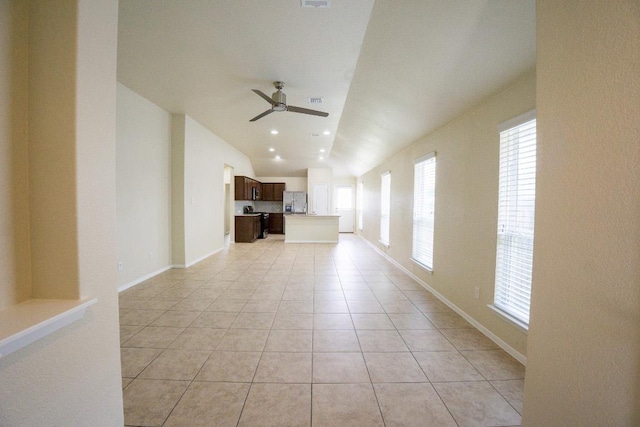 5865 Urbano Bnd, Round Rock, TX 78665 - unfurnished living room with ceiling fan, light tile patterned flooring, and lofted ceiling