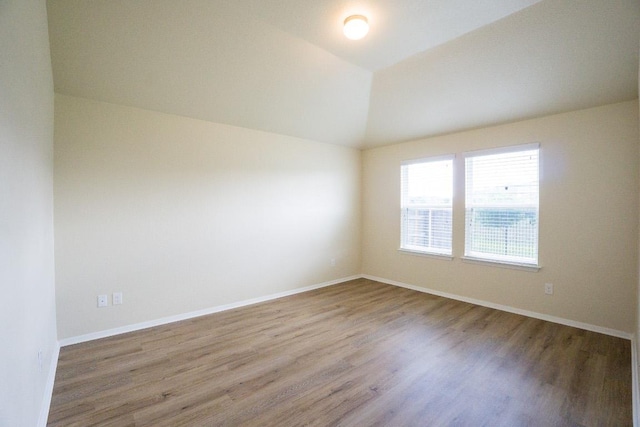 5865 Urbano Bnd, Round Rock, TX 78665 - spare room featuring wood finished floors and vaulted ceiling
