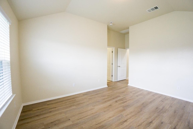 5865 Urbano Bnd, Round Rock, TX 78665 - unfurnished room featuring vaulted ceiling, light wood-style floors, and plenty of natural light