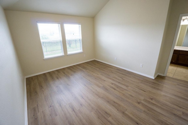 5865 Urbano Bnd, Round Rock, TX 78665 - unfurnished room with vaulted ceiling and light wood finished floors