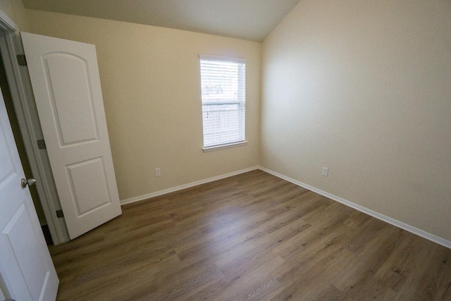 5865 Urbano Bnd, Round Rock, TX 78665 - spare room featuring wood finished floors and lofted ceiling
