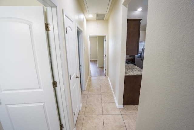 5865 Urbano Bnd, Round Rock, TX 78665 - hall with attic access, light tile patterned flooring, a textured wall, and recessed lighting