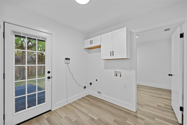 5809 Cherry Creek Dr, Austin, TX 78745 - washroom featuring cabinet space, light wood-style flooring, hookup for a washing machine, electric dryer hookup, and hookup for a gas dryer
