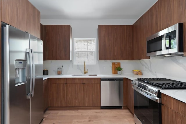 5304 Samuel Huston Ave Unit B, Austin, TX 78721 - kitchen featuring appliances with stainless steel finishes, modern cabinets, light countertops, and light wood-style flooring
