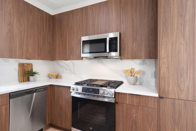 5304 Samuel Huston Ave Unit B, Austin, TX 78721 - kitchen featuring stainless steel appliances, modern cabinets, light countertops, tasteful backsplash, and brown cabinets