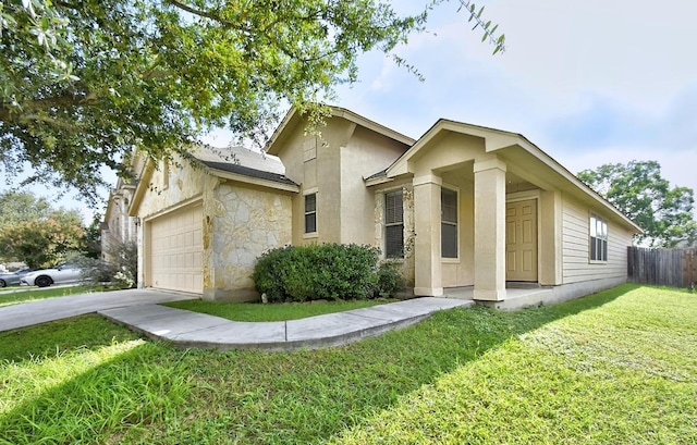 10423 Ancient Anchor, San Antonio, TX 78245 - view of front of house featuring an attached garage, concrete driveway, stone siding, and stucco siding