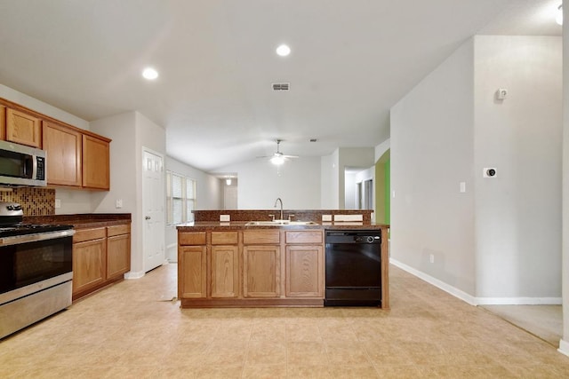 10423 Ancient Anchor, San Antonio, TX 78245 - kitchen with appliances with stainless steel finishes, ceiling fan, dark countertops, backsplash, and recessed lighting