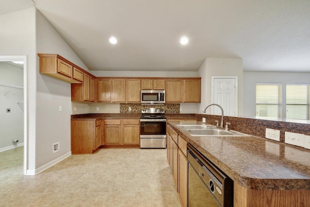 10423 Ancient Anchor, San Antonio, TX 78245 - kitchen featuring appliances with stainless steel finishes, decorative backsplash, dark countertops, an island with sink, and lofted ceiling