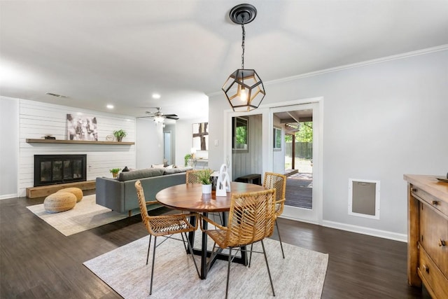 3207 Harpers Ferry Ln, Austin, TX 78745 - dining space featuring dark wood-style flooring, crown molding, recessed lighting, a glass covered fireplace, and a ceiling fan