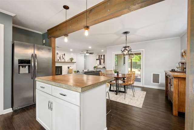 3207 Harpers Ferry Ln, Austin, TX 78745 - kitchen with stainless steel fridge with ice dispenser, ornamental molding, dark wood-style floors, white cabinetry, and recessed lighting