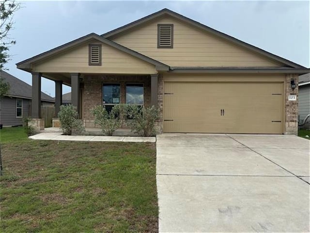 103 Beth Ann Loop, Taylor, TX 76574 - view of front of home featuring covered porch, an attached garage, concrete driveway, and a front yard