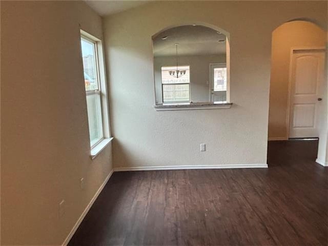 103 Beth Ann Loop, Taylor, TX 76574 - unfurnished room featuring wood finished floors, arched walkways, and healthy amount of natural light