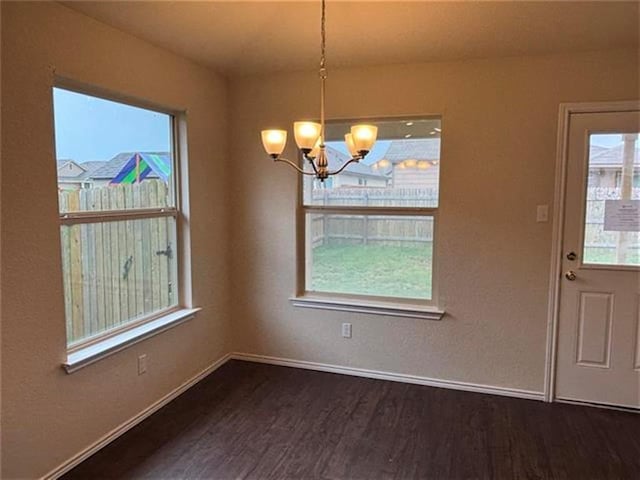 103 Beth Ann Loop, Taylor, TX 76574 - unfurnished dining area with dark wood-type flooring, a chandelier, and healthy amount of natural light
