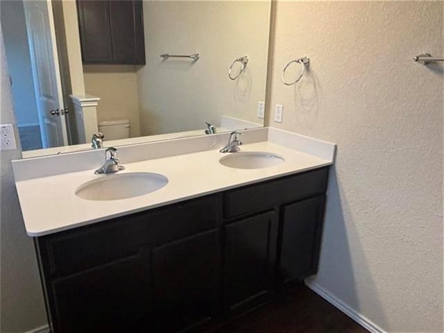 103 Beth Ann Loop, Taylor, TX 76574 - bathroom featuring a textured wall and double vanity