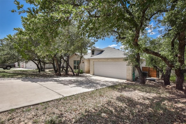 21510 Paine Ave, Lago Vista, TX 78645 - view of front of property featuring driveway, a garage, and stone siding
