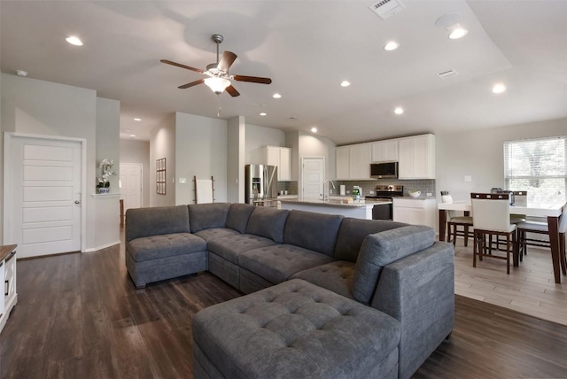 21510 Paine Ave, Lago Vista, TX 78645 - living area featuring dark wood-style flooring, a ceiling fan, and recessed lighting