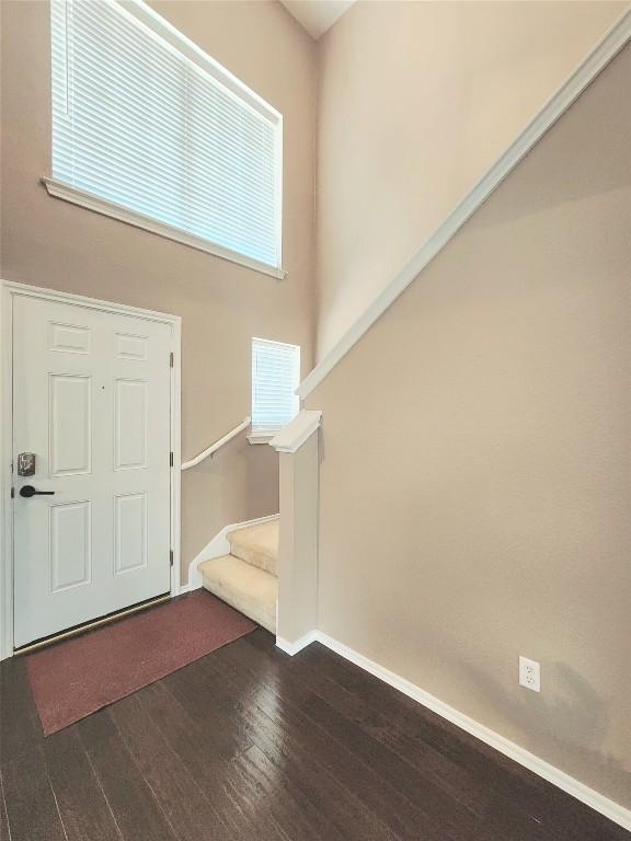203 Pheasant Trl, Bastrop, TX 78602 - foyer entrance with dark wood-type flooring and stairs