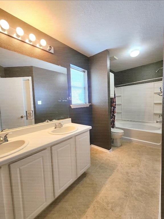 203 Pheasant Trl, Bastrop, TX 78602 - bathroom featuring shower / tub combo with curtain, double vanity, tile patterned flooring, and a textured ceiling