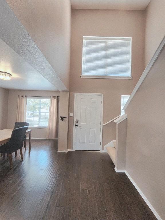 203 Pheasant Trl, Bastrop, TX 78602 - entryway featuring stairs, wood finished floors, and a high ceiling