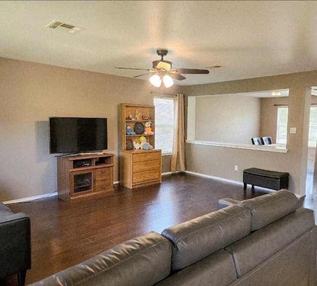 203 Pheasant Trl, Bastrop, TX 78602 - living room featuring dark wood-type flooring, a ceiling fan, and healthy amount of natural light
