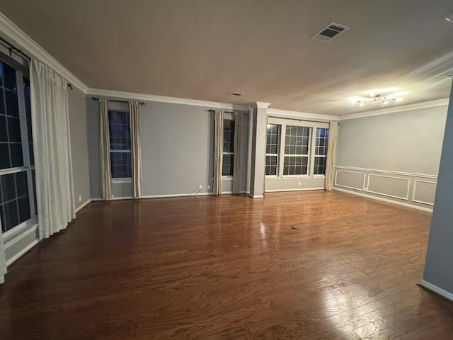 10204 Tenava Ct, Austin, TX 78726 - spare room featuring crown molding, wood finished floors, a decorative wall, and a wainscoted wall