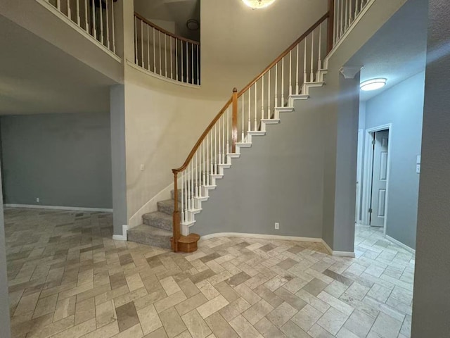 10204 Tenava Ct, Austin, TX 78726 - stairway featuring baseboards and a towering ceiling
