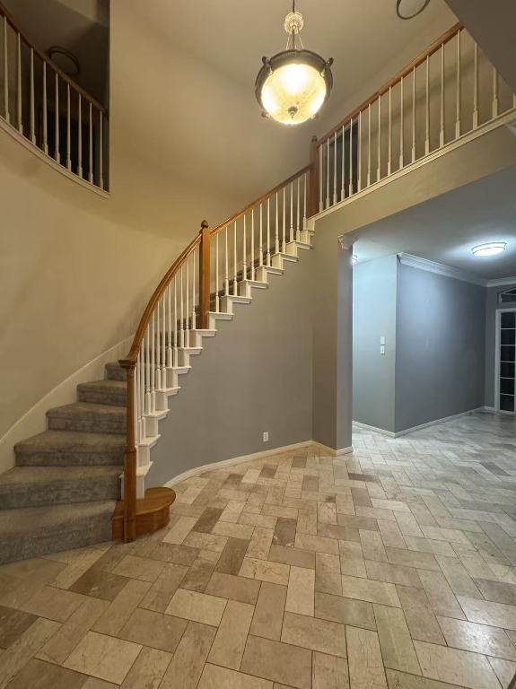 10204 Tenava Ct, Austin, TX 78726 - staircase featuring a towering ceiling and ornamental molding