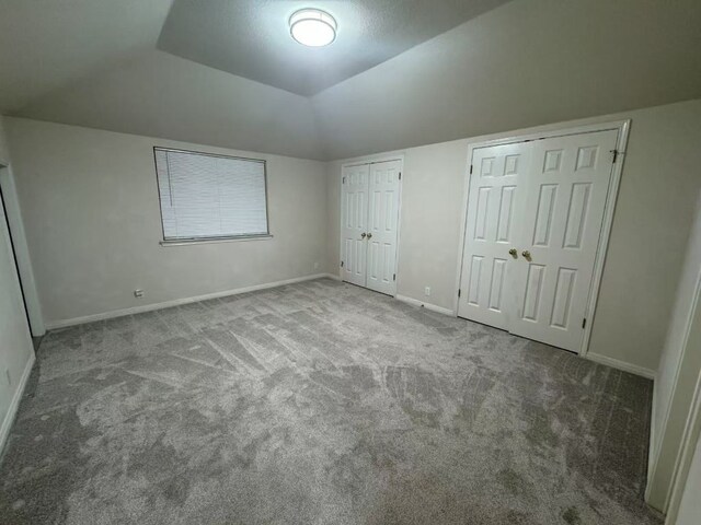 10204 Tenava Ct, Austin, TX 78726 - unfurnished bedroom featuring carpet flooring, two closets, and vaulted ceiling