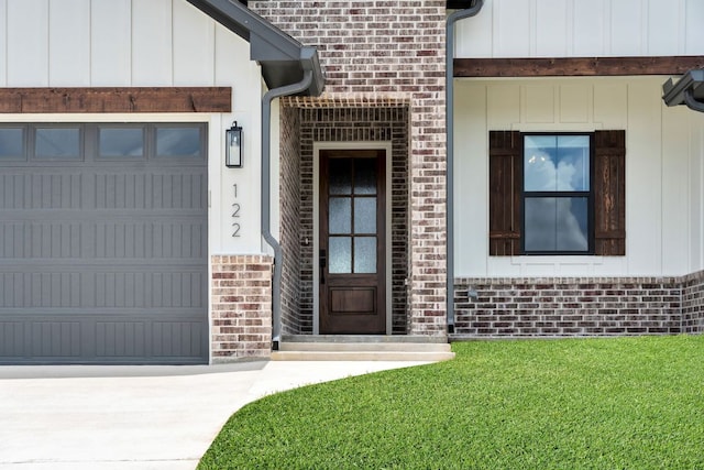122 Buffalo Ridge Rd, Giddings, TX 78942 - property entrance with board and batten siding, a garage, brick siding, and concrete driveway