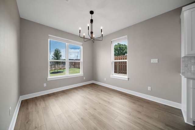 122 Buffalo Ridge Rd, Giddings, TX 78942 - spare room with a chandelier, healthy amount of natural light, and wood finished floors