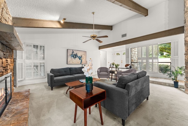 605 Flamingo Blvd, Lakeway, TX 78734 - living room featuring carpet floors, a fireplace, beamed ceiling, a ceiling fan, and a textured ceiling