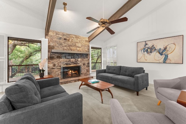 605 Flamingo Blvd, Lakeway, TX 78734 - carpeted living room featuring beam ceiling, a ceiling fan, a fireplace, and high vaulted ceiling