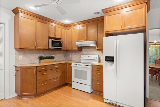 605 Flamingo Blvd, Lakeway, TX 78734 - kitchen featuring white appliances, under cabinet range hood, light wood-type flooring, and ceiling fan