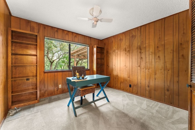 605 Flamingo Blvd, Lakeway, TX 78734 - home office with wooden walls, carpet flooring, a ceiling fan, and a textured ceiling