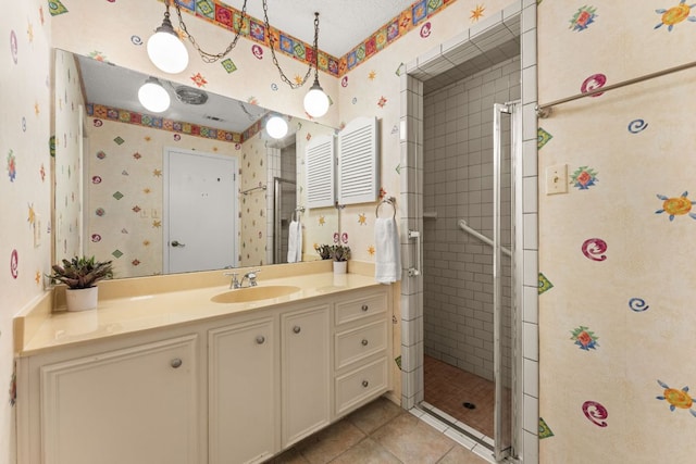 605 Flamingo Blvd, Lakeway, TX 78734 - full bath with wallpapered walls, vanity, a stall shower, and tile patterned floors